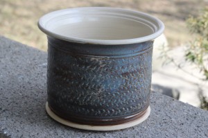 Wheel thrown nice sized white clay vessel, nicely textured sides show off brown and blue glaze with white interior.