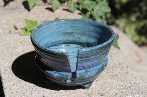 I had fun with this knitting bowl! I bellied out the side to create a ridge that has flowers stamped on it. The glaze is a deeper nigh time sky blue that also pools into the different shapes of the clay lending itself to a variated color of blue. 