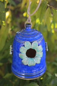 I love this vibrant blue glaze on white clay, a bit taller, small bird house with leaves all around the opening, and flowers places randomly along the sides. Midfire clay is outdoor safe from the elements. 