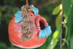 Small Birdhouse for our tiny feathered friends is glazed with Coyote Sedona Sunset glaze, a warm orange wash over white clay. I applied small golden mum flowers and baby blue/green leaves. 